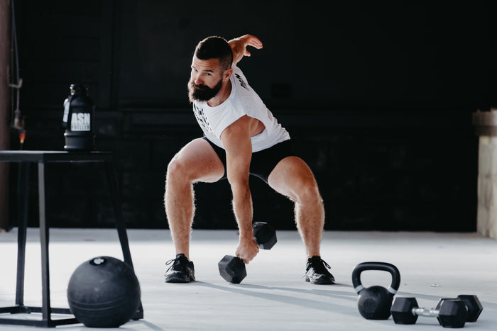 a man lifting up a dumbell 