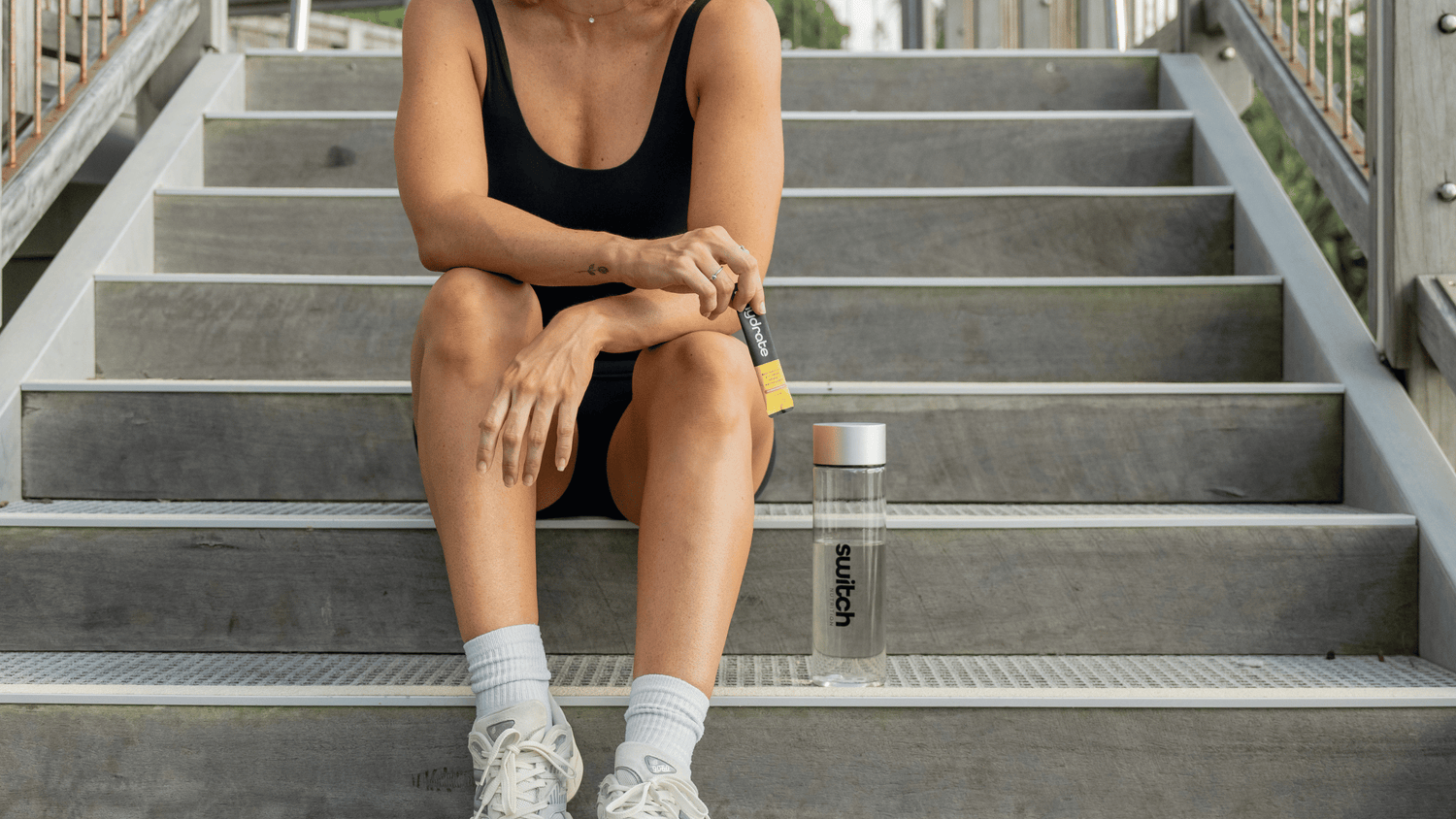 woman on stairs with switch hydrate 